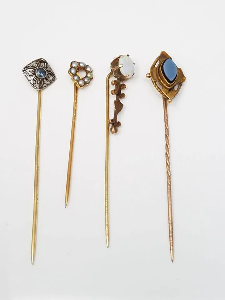 Four 8k - 18k Yellow Gold Pins